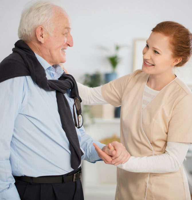 caregiver-helping-senior-man
